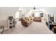 This living room features a ceiling fan, plush sofas, and two large windows at 115 Ladybug Ct, Statesville, NC 28625
