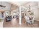 Open-concept living space with hardwood floors, a kitchen, and a dining area at 115 Ladybug Ct, Statesville, NC 28625