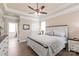 This main bedroom features a ceiling fan, wood floors and a doorway leading to the main bathroom at 115 Ladybug Ct, Statesville, NC 28625