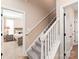The staircase features carpeted steps and white wood railings, and overlooks the bedroom at 115 Ladybug Ct, Statesville, NC 28625