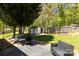 Backyard features a shed, hammock, patio furniture, and lush landscaping at 119 Sweet Martha Dr, Mooresville, NC 28115