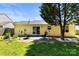 Spacious backyard with patio, comfortable seating, mature tree, and a well-kept lawn at 119 Sweet Martha Dr, Mooresville, NC 28115