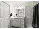 Bathroom with a white vanity, neutral walls, and a decorative mirror above the sink at 119 Sweet Martha Dr, Mooresville, NC 28115