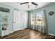 Bedroom with light blue walls, ceiling fan, and a well-lit room with a big window at 119 Sweet Martha Dr, Mooresville, NC 28115