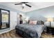 Well-lit bedroom with luxury vinyl flooring, a ceiling fan, and a mirror at 119 Sweet Martha Dr, Mooresville, NC 28115