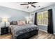 Bedroom with wood-look floors, bedside tables with lamps, and a ceiling fan at 119 Sweet Martha Dr, Mooresville, NC 28115