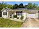 Inviting one-story home with a well-maintained lawn, attached garage, and classic curb appeal at 119 Sweet Martha Dr, Mooresville, NC 28115