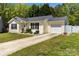 Charming single-story home features a well-manicured lawn and attached garage at 119 Sweet Martha Dr, Mooresville, NC 28115