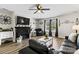 Stylish living room with a fireplace, TV, dark furniture, and contemporary decor at 119 Sweet Martha Dr, Mooresville, NC 28115