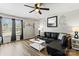 Spacious living room with modern decor, dark drapes, wood-look flooring, and ample natural light at 119 Sweet Martha Dr, Mooresville, NC 28115