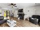 Open-concept living space featuring a fireplace, dark furniture, and an adjacent dining area at 119 Sweet Martha Dr, Mooresville, NC 28115