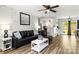 Cozy living room featuring modern furniture, a ceiling fan, and an open layout to the kitchen at 119 Sweet Martha Dr, Mooresville, NC 28115