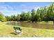Scenic view of a tranquil pond with a fountain and a peaceful seating area to relax and enjoy at 119 Sweet Martha Dr, Mooresville, NC 28115