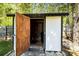 Open shed entrance revealing its interior, situated in a green and spacious backyard at 119 Sweet Martha Dr, Mooresville, NC 28115