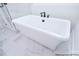 Stylish freestanding bathtub with modern fixtures, perfect for a relaxing bath at 122 Huntcliff Dr, Statesville, NC 28677
