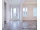 Bright entryway featuring white trim, modern door with sidelights, and light hardwood floors at 122 Huntcliff Dr, Statesville, NC 28677