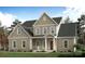 Charming new construction home with a covered front porch, green lawn and craftsman style accents at 122 Huntcliff Dr, Statesville, NC 28677