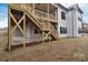 Two-story home featuring a wooden deck, stairs leading to a yard, and multiple windows for natural light at 122 Huntcliff Dr, Statesville, NC 28677