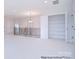 Hallway featuring white carpet with staircase and lighting fixtures at 122 Huntcliff Dr, Statesville, NC 28677