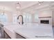 Bright kitchen showcasing a large island with marble countertops, farmhouse sink, and stainless steel appliances at 122 Huntcliff Dr, Statesville, NC 28677