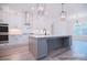 Modern kitchen features white cabinets, stainless steel appliances, a large island, and stylish pendant lighting at 122 Huntcliff Dr, Statesville, NC 28677
