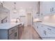 Modern kitchen with white cabinetry, stainless steel appliances, and a large island with marble countertops at 122 Huntcliff Dr, Statesville, NC 28677