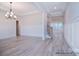 Bright and airy living room featuring elegant lighting, crown molding, and beautiful flooring at 122 Huntcliff Dr, Statesville, NC 28677