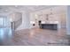 Open floor plan with stairs, white walls, light hardwood floors, gourmet kitchen and modern lighting at 122 Huntcliff Dr, Statesville, NC 28677