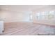 Open living room featuring recessed lighting, a side door, an abundance of natural light and wood-style flooring at 122 Huntcliff Dr, Statesville, NC 28677