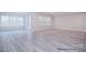 Open-plan living space featuring laminate flooring, large windows, and neutral decor at 122 Huntcliff Dr, Statesville, NC 28677