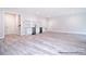 Living room features laminate floors, white shelving and cabinets, and stainless steel appliances at 122 Huntcliff Dr, Statesville, NC 28677
