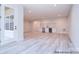 Bright open-plan living area with door to patio, wet bar and laminate floors at 122 Huntcliff Dr, Statesville, NC 28677