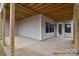 Covered patio featuring a concrete floor, white trim, and wooden beams for an outdoor living space at 122 Huntcliff Dr, Statesville, NC 28677