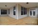 Light and airy covered patio with wood floors, white trim, large windows and a door at 122 Huntcliff Dr, Statesville, NC 28677