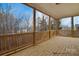 Spacious wood porch with wood railing and a beautiful lake view at 122 Huntcliff Dr, Statesville, NC 28677