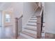 Elegant staircase with wood treads, white risers, and a modern black railing, enhancing the home's interior at 122 Huntcliff Dr, Statesville, NC 28677