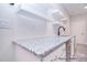 Close up of wet bar featuring granite countertops, white cabinets, floating shelves, and tiled backsplash at 122 Huntcliff Dr, Statesville, NC 28677
