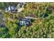 Aerial view of a luxurious home featuring a backyard pool, perfectly nestled amongst lush green trees at 127 Holt Ln, Mooresville, NC 28117