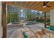 An outdoor oasis with a covered patio, pool, hot tub, and a lush, landscaped backyard at 127 Holt Ln, Mooresville, NC 28117