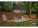 Backyard retreat featuring a fire pit and natural landscaping, providing a tranquil escape at 127 Holt Ln, Mooresville, NC 28117