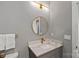 Chic bathroom featuring a gold framed mirror, modern lighting, and a marble countertop at 127 Holt Ln, Mooresville, NC 28117
