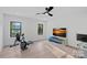 Spacious bonus room includes a ceiling fan, exercise equipment, and natural light at 127 Holt Ln, Mooresville, NC 28117