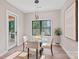 Cozy dining area with lake view, modern light fixture, and access to the outdoors at 127 Holt Ln, Mooresville, NC 28117
