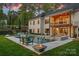Beautiful home exterior featuring a pool, a patio, and a spacious lawn area at 127 Holt Ln, Mooresville, NC 28117
