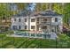 Spacious backyard with a pool, patio, fire pit, and a well-manicured lawn for outdoor enjoyment at 127 Holt Ln, Mooresville, NC 28117
