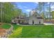Inviting exterior of home with manicured lawn, rock drainage detail and a charming covered porch at 127 Holt Ln, Mooresville, NC 28117