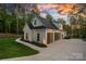 Modern farmhouse with an attached three-car garage and concrete driveway with walkway to manicured yard at 127 Holt Ln, Mooresville, NC 28117