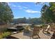 Picturesque lakefront property with private dock, cozy seating area, and tranquil water views under a sunny sky at 127 Holt Ln, Mooresville, NC 28117