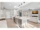 Open-concept living room with modern island, fireplace, and view of the kitchen at 127 Holt Ln, Mooresville, NC 28117