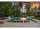 Gorgeous in-ground pool with built-in sun loungers and a spa, surrounded by lush landscaping at 127 Holt Ln, Mooresville, NC 28117